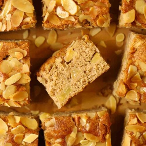 Apple cake squares on a wooden board.