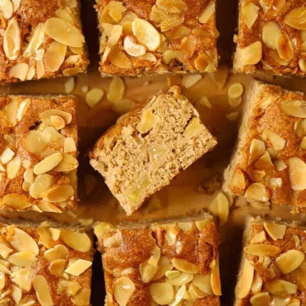 Squares of cooked apple cake with nutty topping.