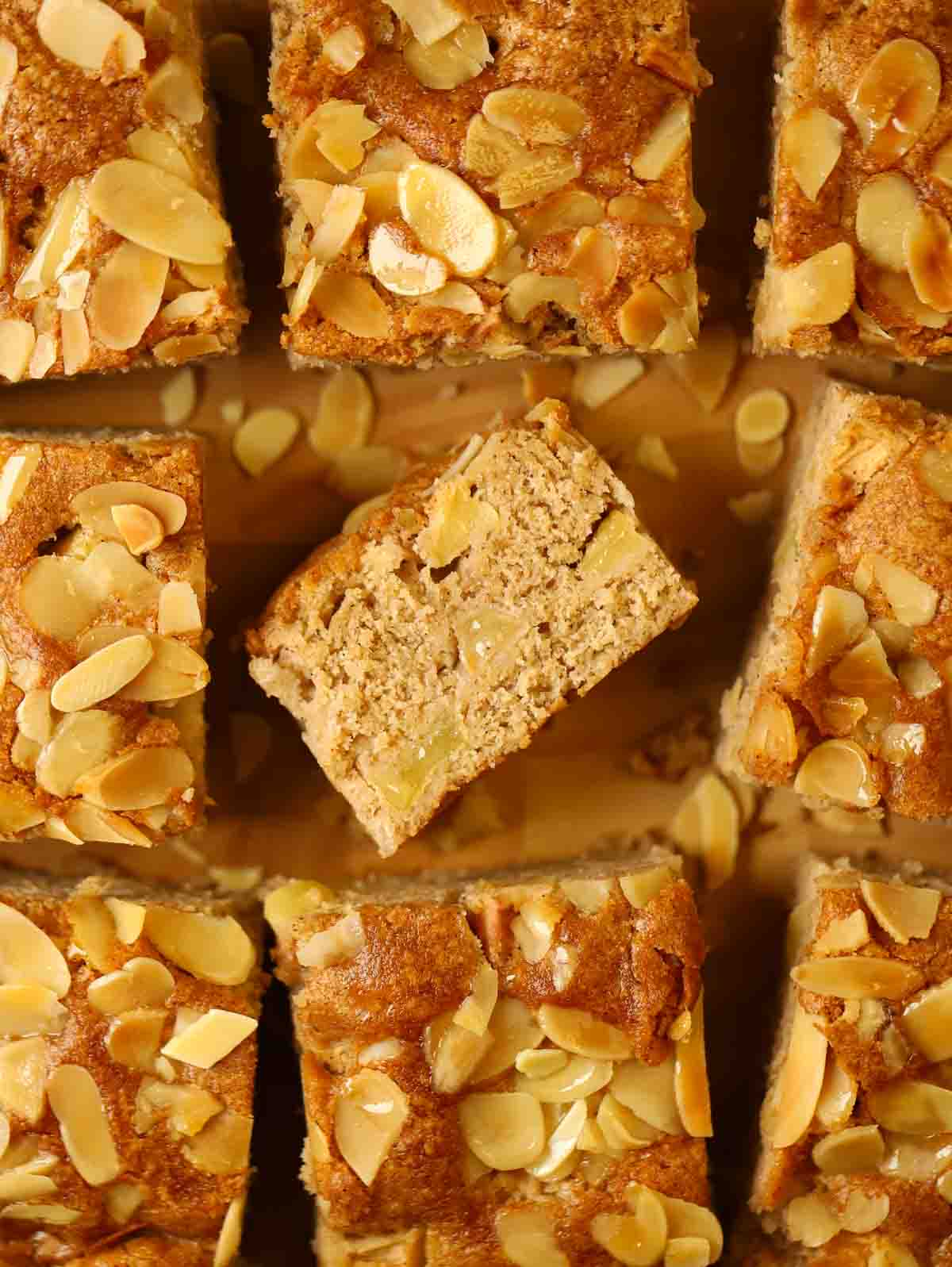 Squares of apple cake with one in the middle on its side to show the middle.