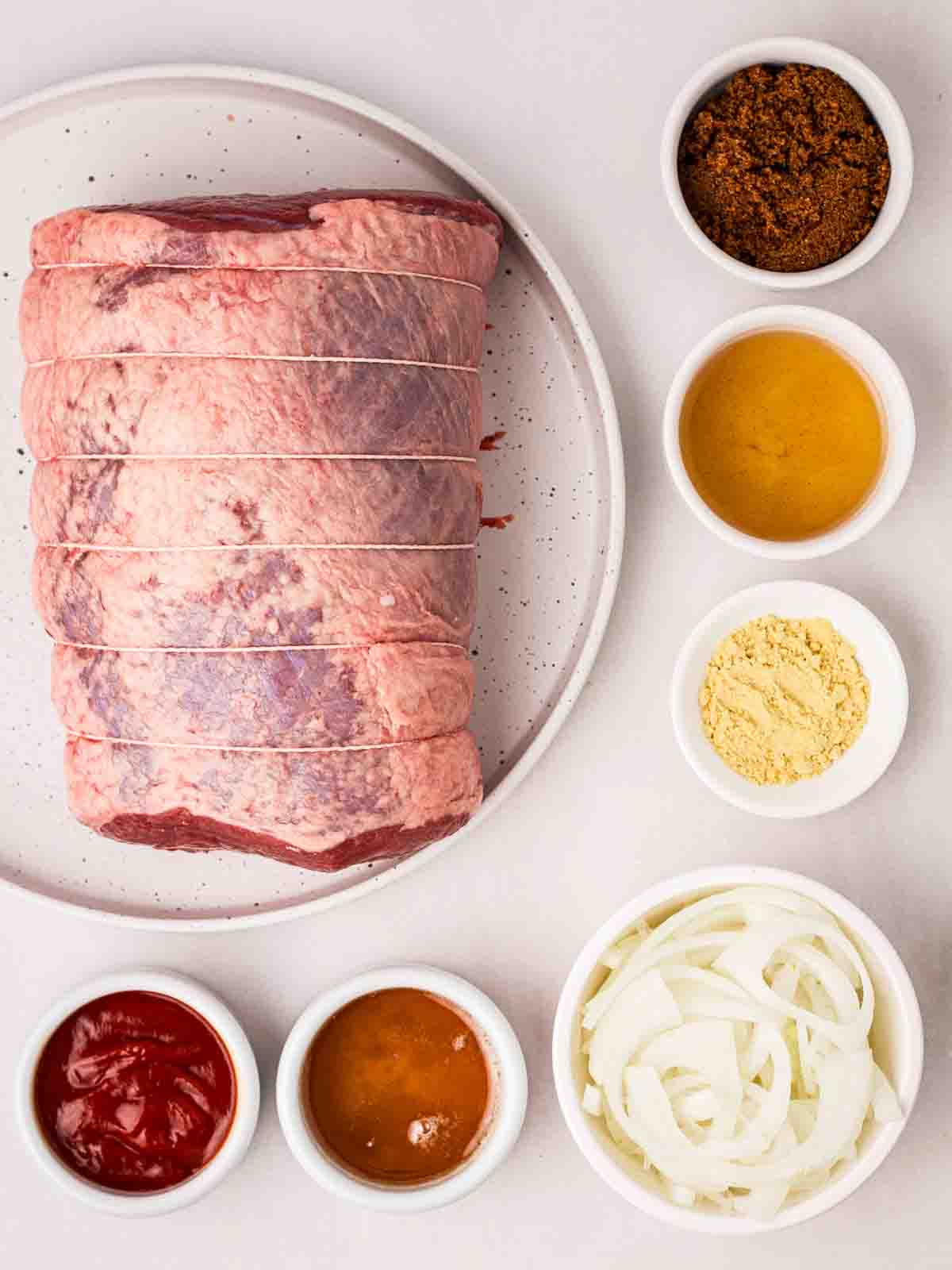 The ingredients for making slow cooker beef brisket laid out on a counter.