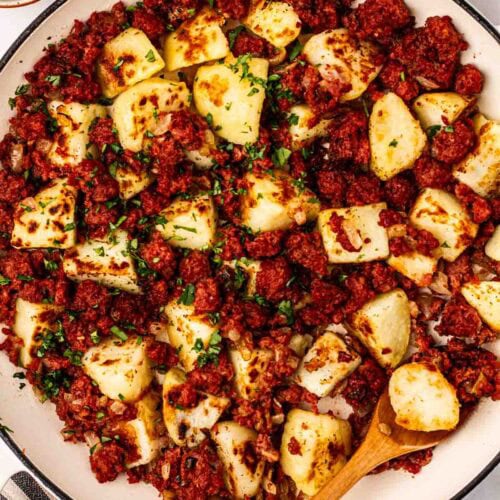 A plate of Corned Beef Hash, with cubes of potatoes and corned beef, on a plate, ready to eat.