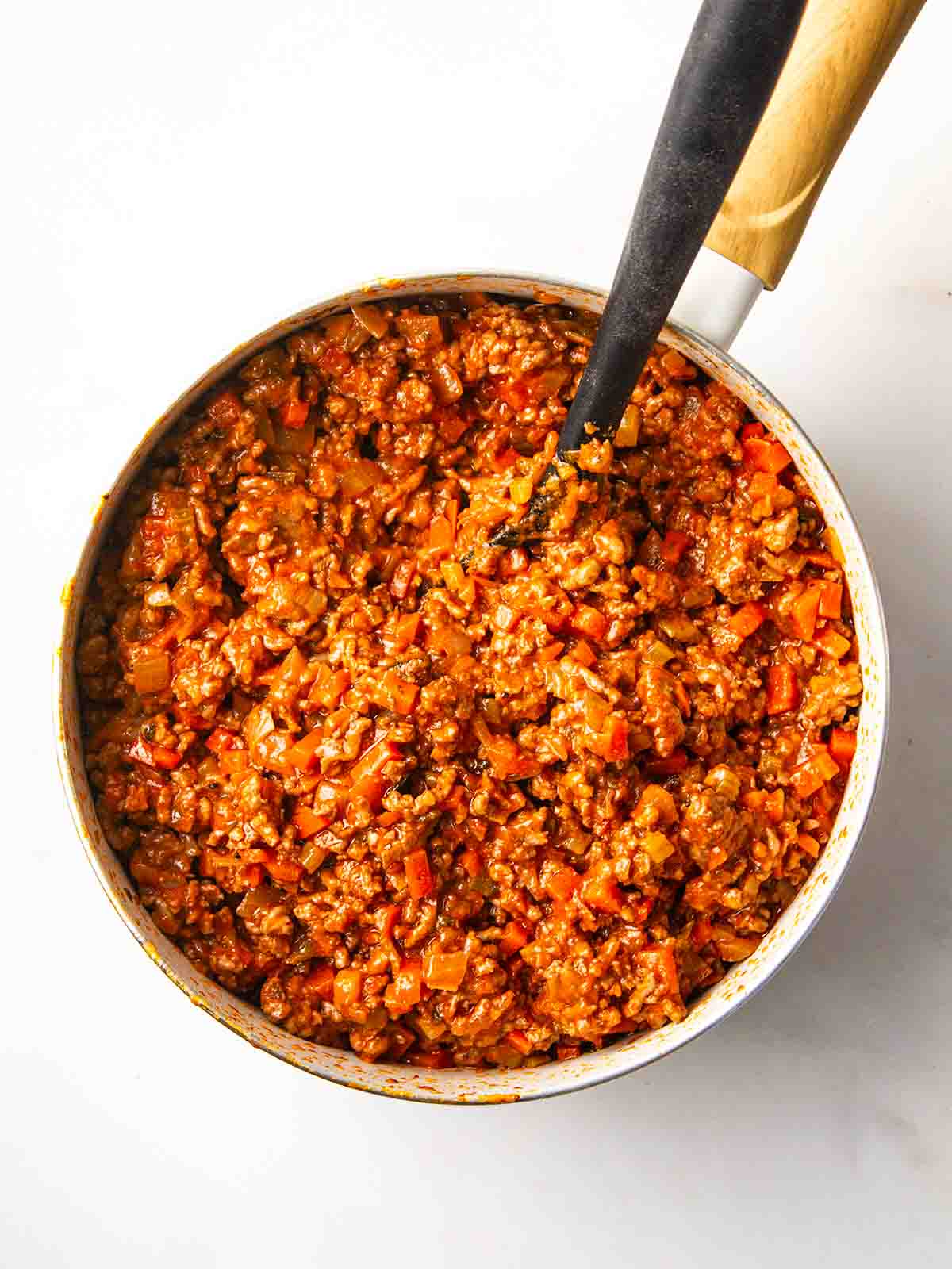 A base sauce in a pan with beef mince and vegetables for step 3 in the recipe for Cottage Pie.