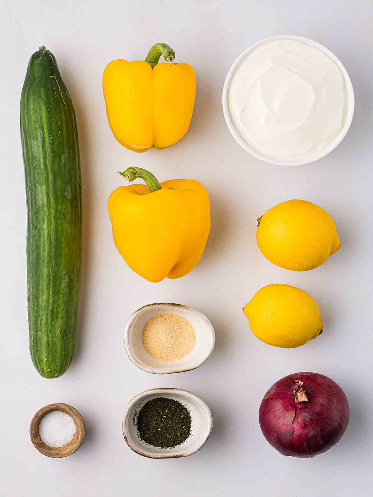 The ingredients for making a Cucumber Salad laid out on a counter top.
