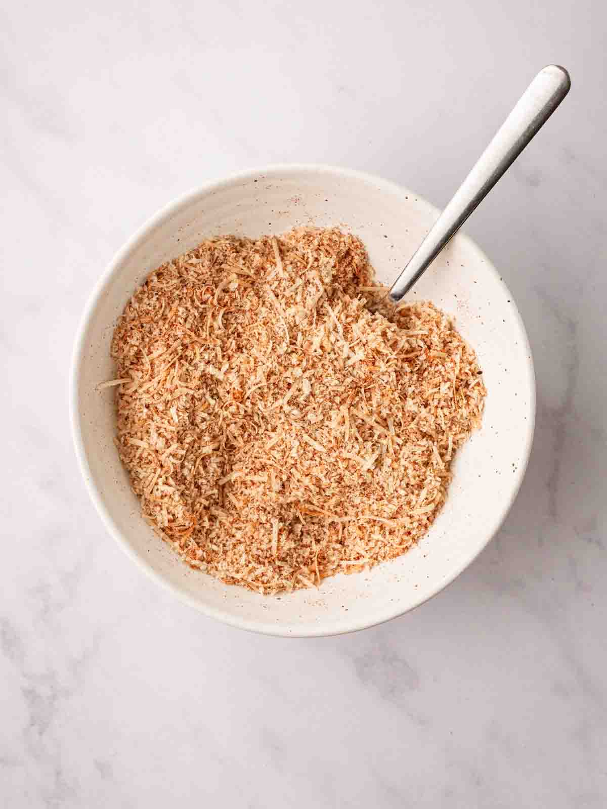 A breadcrumb mixture in a bowl for step 2 in the recipe for homemade chicken nuggets.