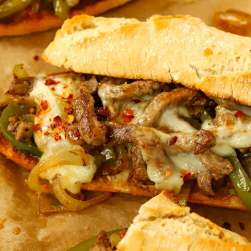 A hot beef sandwich with cheese, otherwise known as a Philly Cheesesteak, ready to eat.