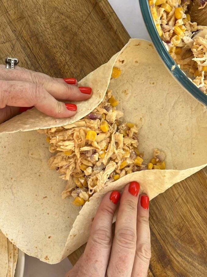 Step 3 in the recipe for Chicken Wraps. Fold the tortilla.