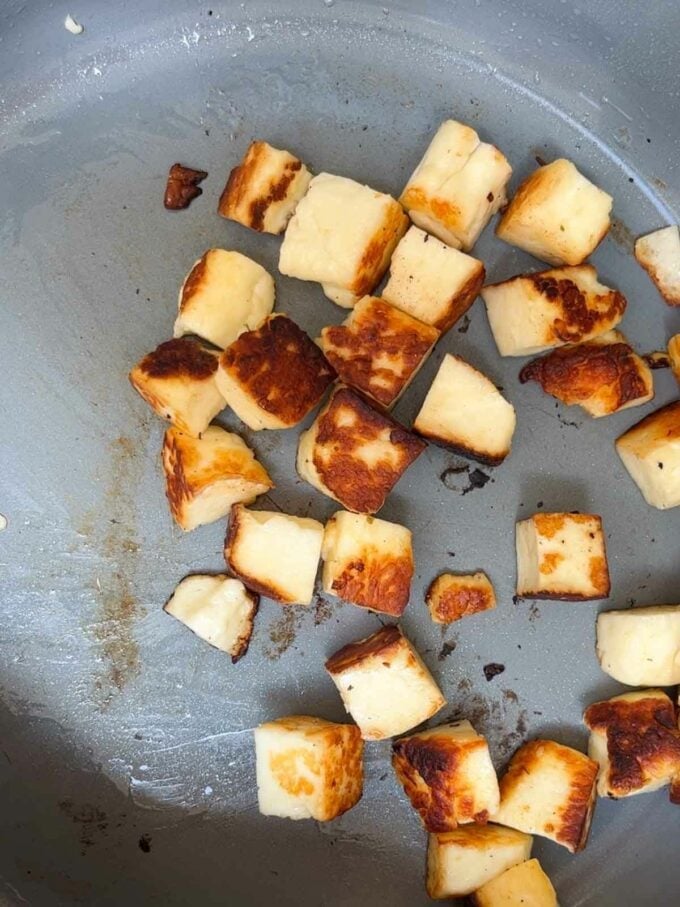 Cubes of halloumi being fried in a pan for the recipe Halloumi Pasta.