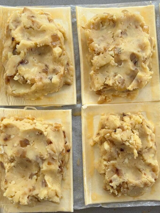 How to make Cheese and Onion pasties. Step 3. Brush egg wash around the edges before placing the top layer of pastry on top.