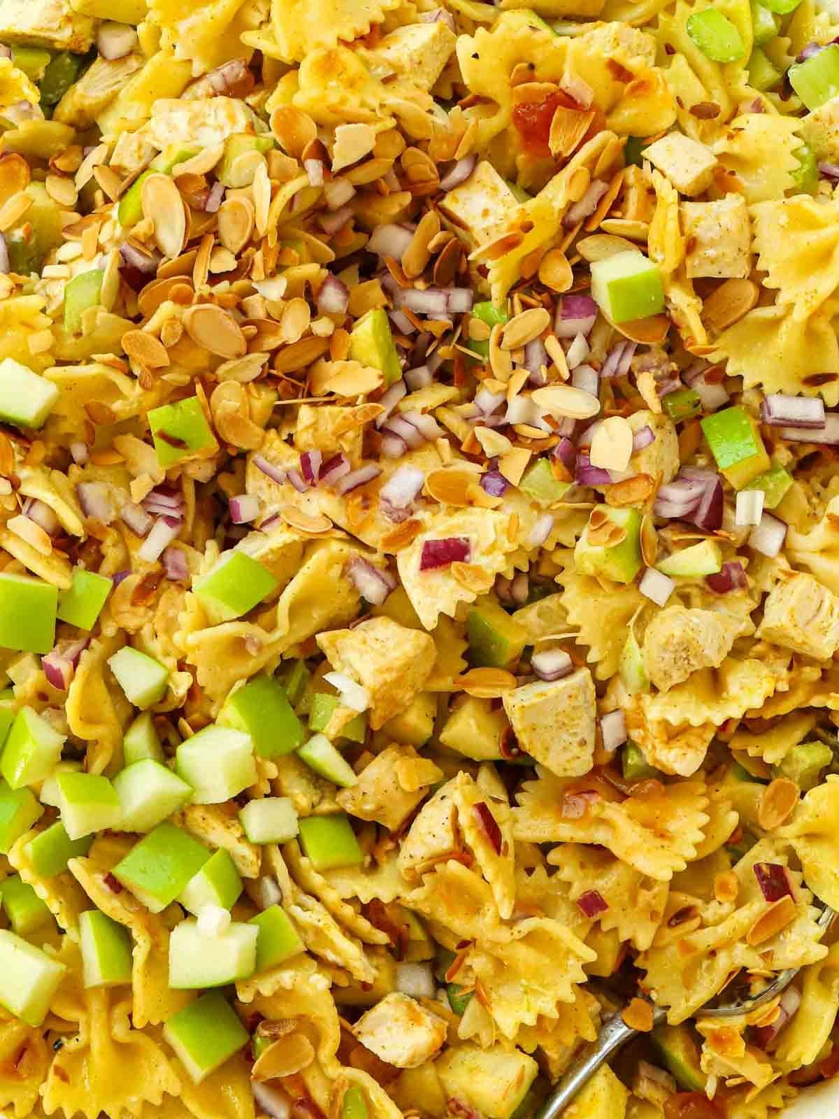 A mixture of pasta, chicken and salad for the recipe Chicken Pasta Salad.