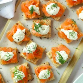 Perfect party food on a serving board. Smoked Salmon Canapés topped with creme fraiche and dill.