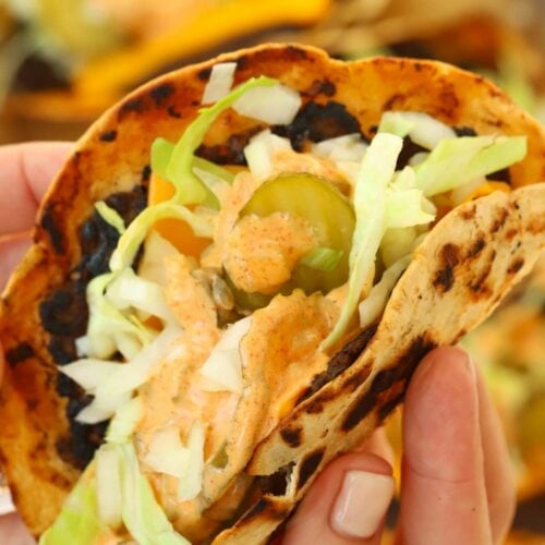 A hand holding up a homemade McDonald's Big Mac Taco.