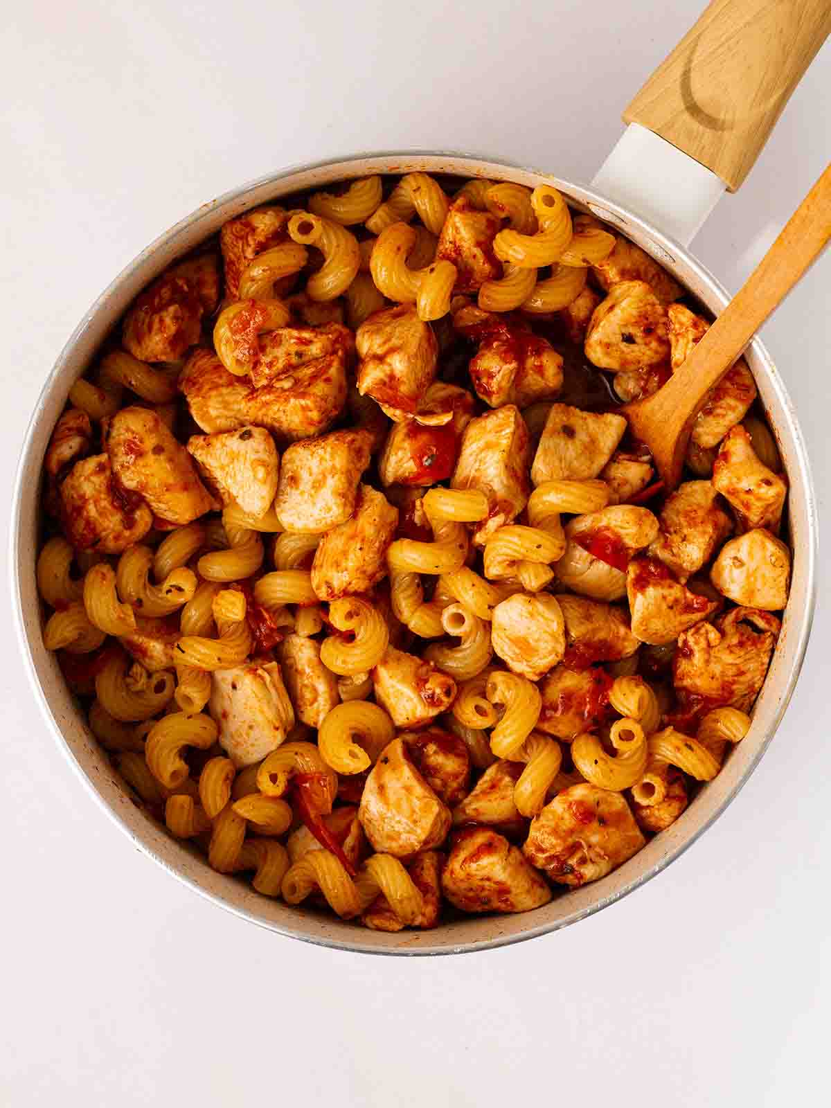 A pan filled with chicken and pasta for step 3 in the recipe for Marry Me Chicken Pasta.
