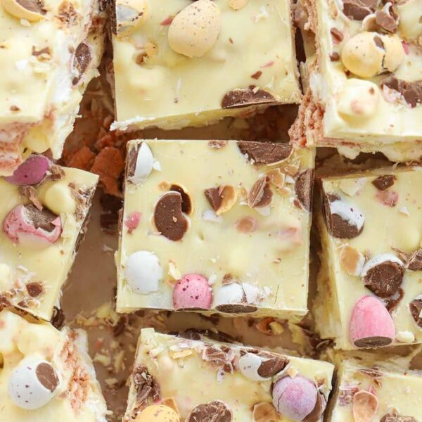 A slab of Easter Mini Egg Rocky Road made with white chocolate, cut into bitesized squares.