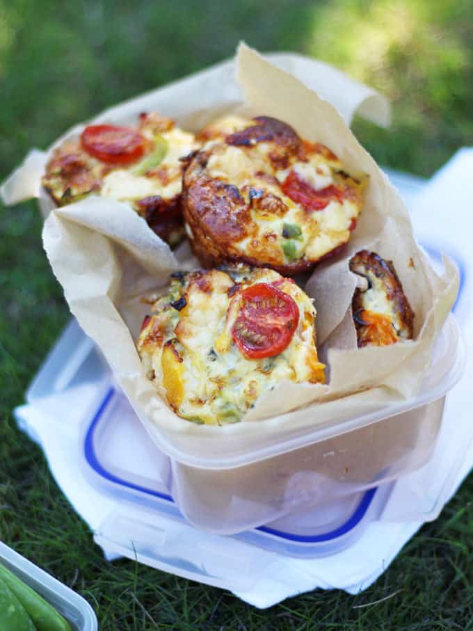 Mini Crustless Quiches in a box on grass, ready for a picnic.