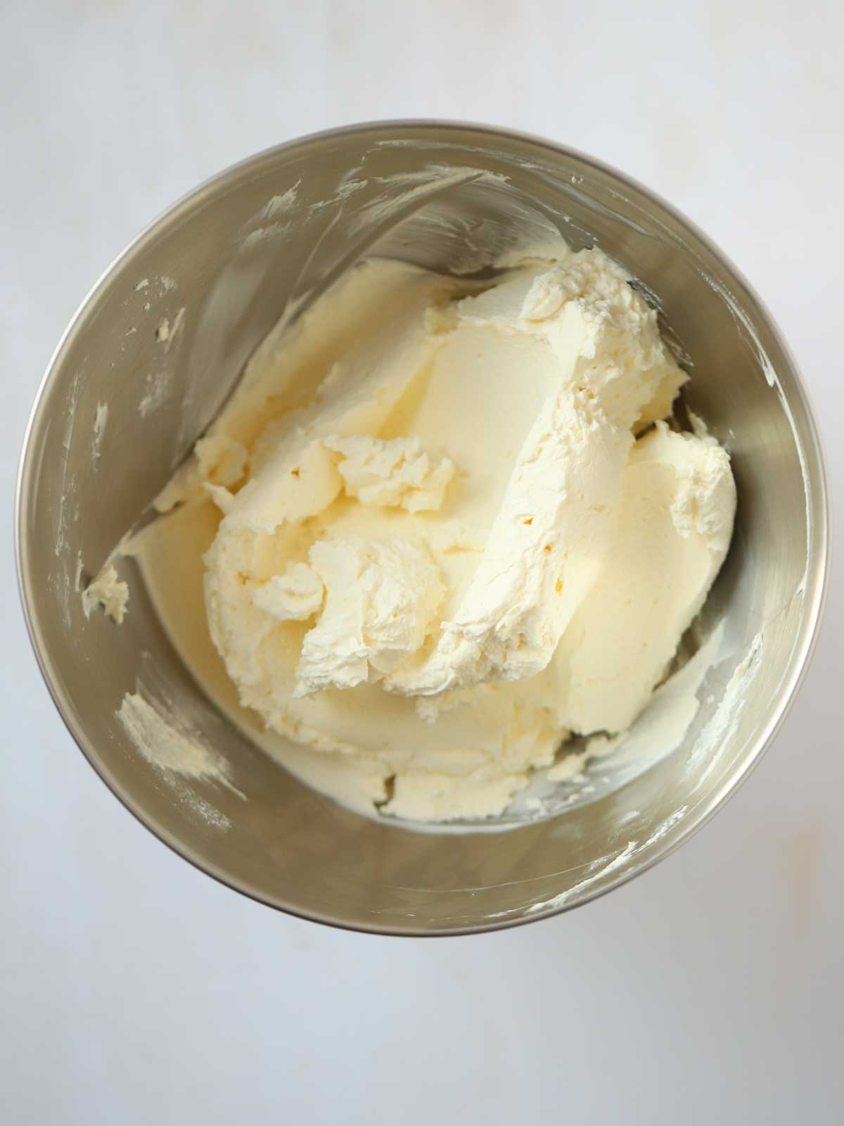 Whipped cream for step 3 in the process of making an Oreo Cheesecake.