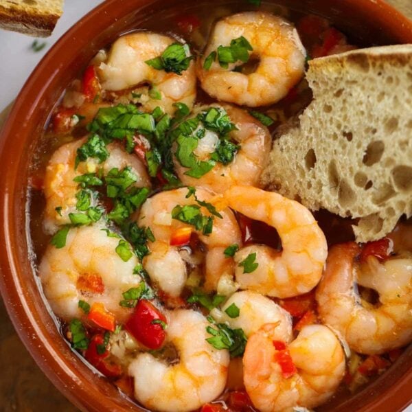 A Spanish tapas dish filled with prawns and herbs and bread dipped in for an easy Gambas Pil Pil recipe.