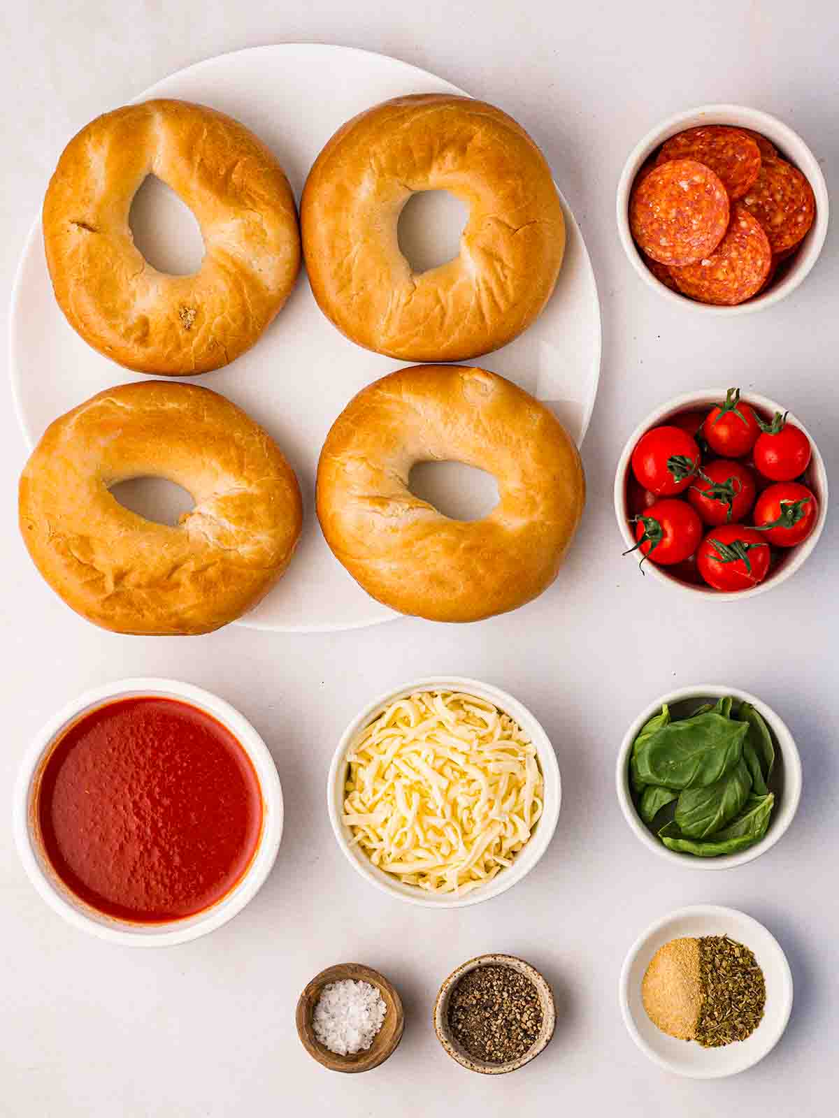The ingredients to make Pizza Bagels laid out on a counter top..