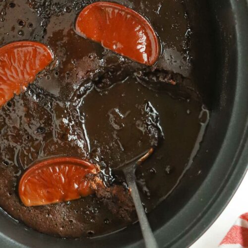 Close up of slow cooker pan with chocolate orange pudding inside.