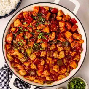 A pan of Sweet and Sour chicken, ready to serve onto plates.