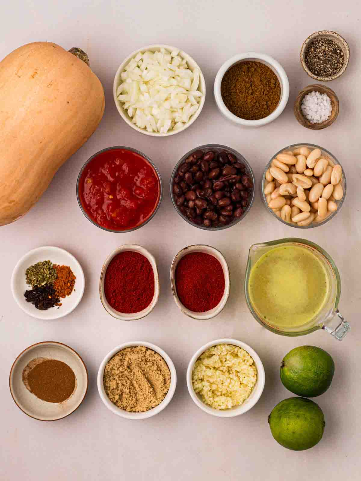 The ingredients for a Vegan Chilli recipe laid out on a counter in bowls.